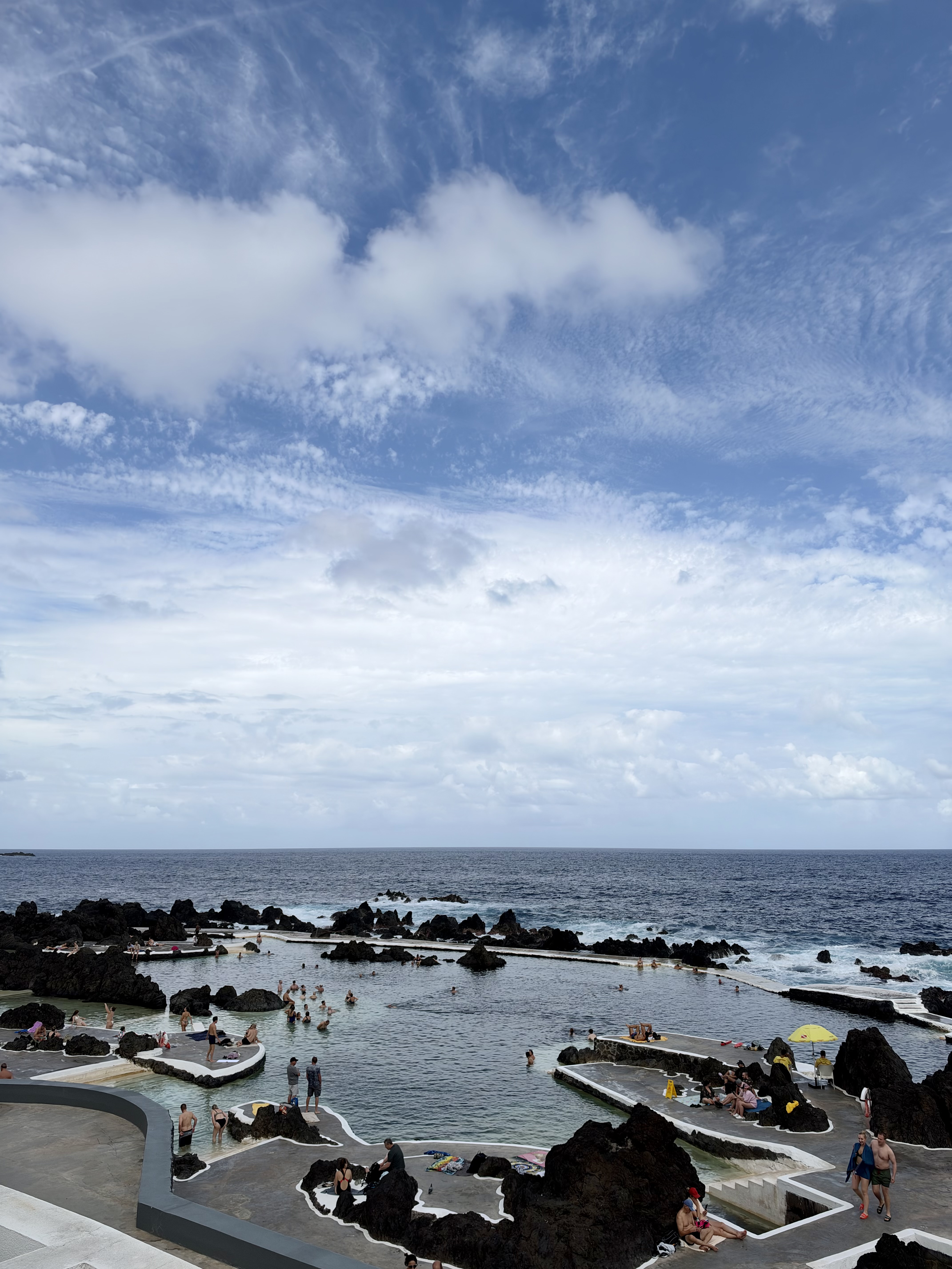 Lava rock pools filled by Atlantic ocean surf at Porto Moniz natural swimming complex