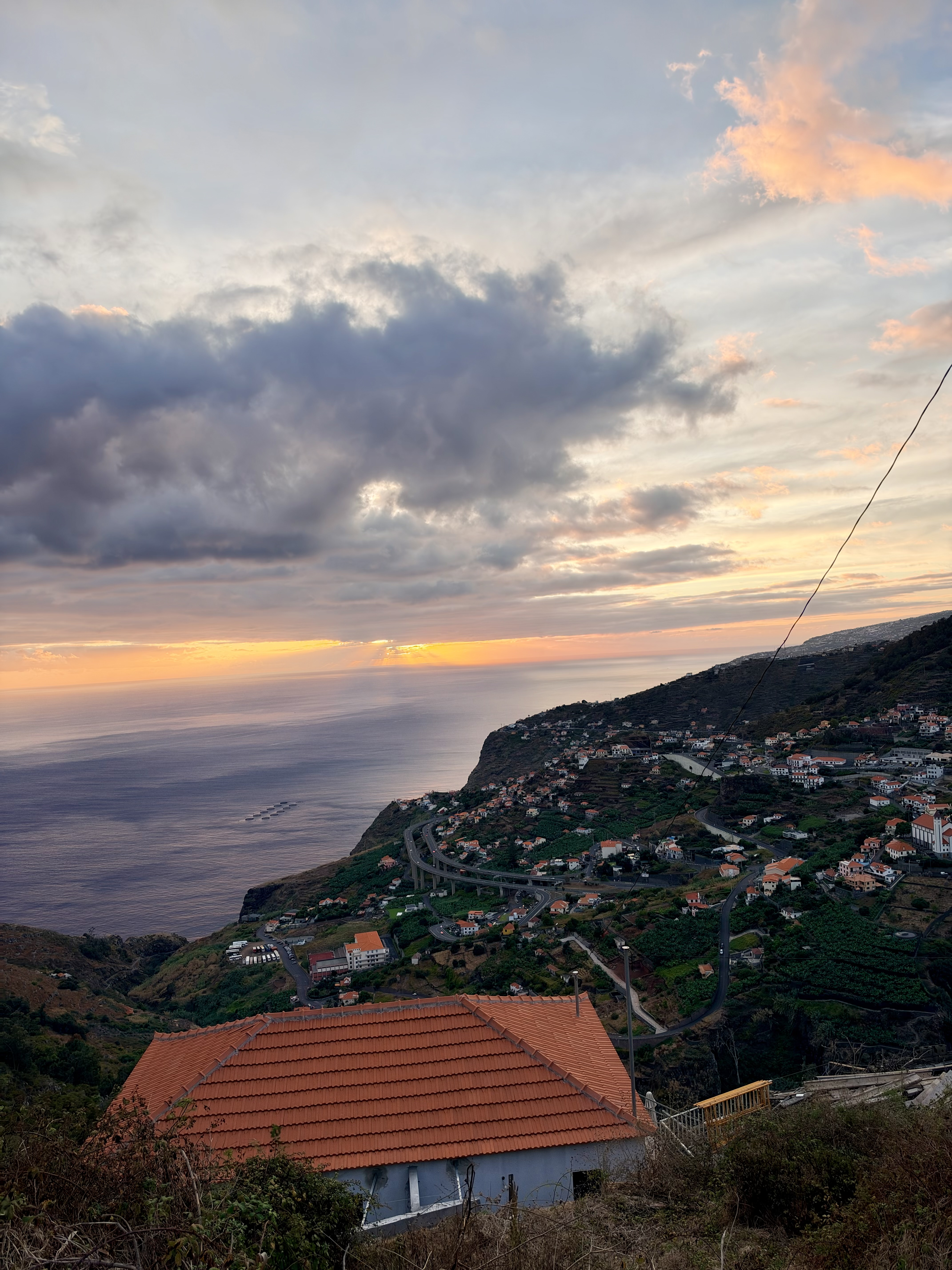 Sunset over the coastal viaduct and fish farms from Rua Comandante Camacho de Freitas in Campanário