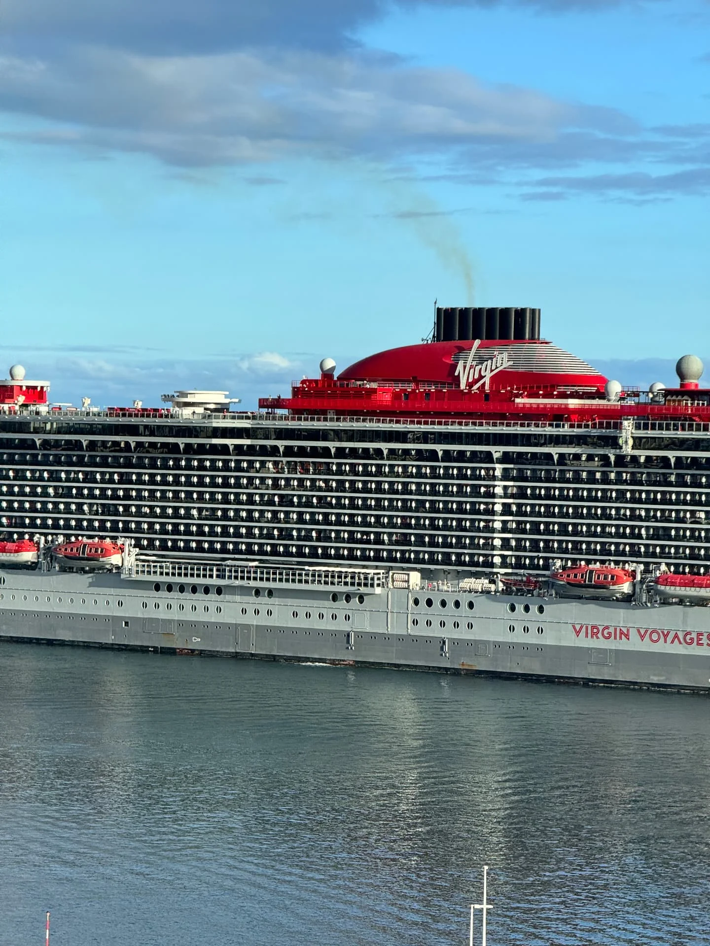 Virgin Voyages’ red funnel above the Funchal cruise pier