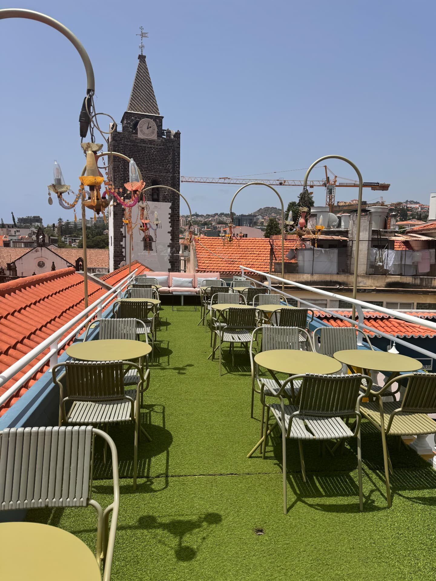 Flamingo Cocktail Bar rooftop terrace at Sé Boutique Hotel, Funchal, with Sé Cathedral tower behind the tables