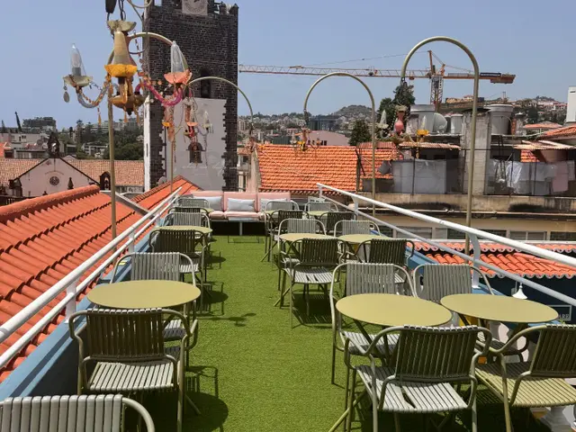 Flamingo Cocktail Bar rooftop terrace at Sé Boutique Hotel, Funchal, with Sé Cathedral tower behind the tables