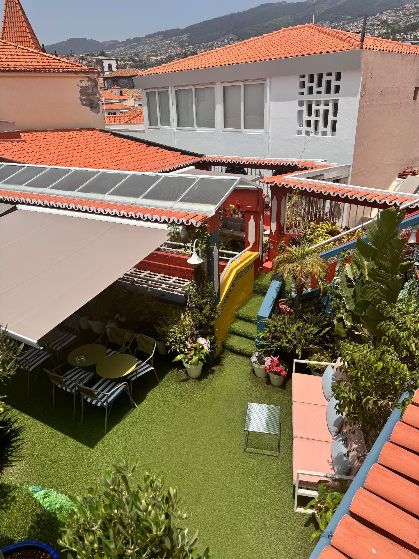 View across the Flamingo rooftop garden terrace in Funchal towards the mountains