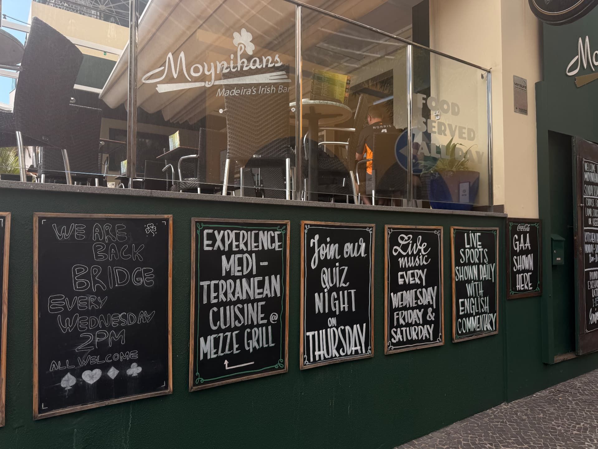 Chalkboard signs outside Moynihan\u0027s Irish Bar listing quiz night, live music and bridge afternoons