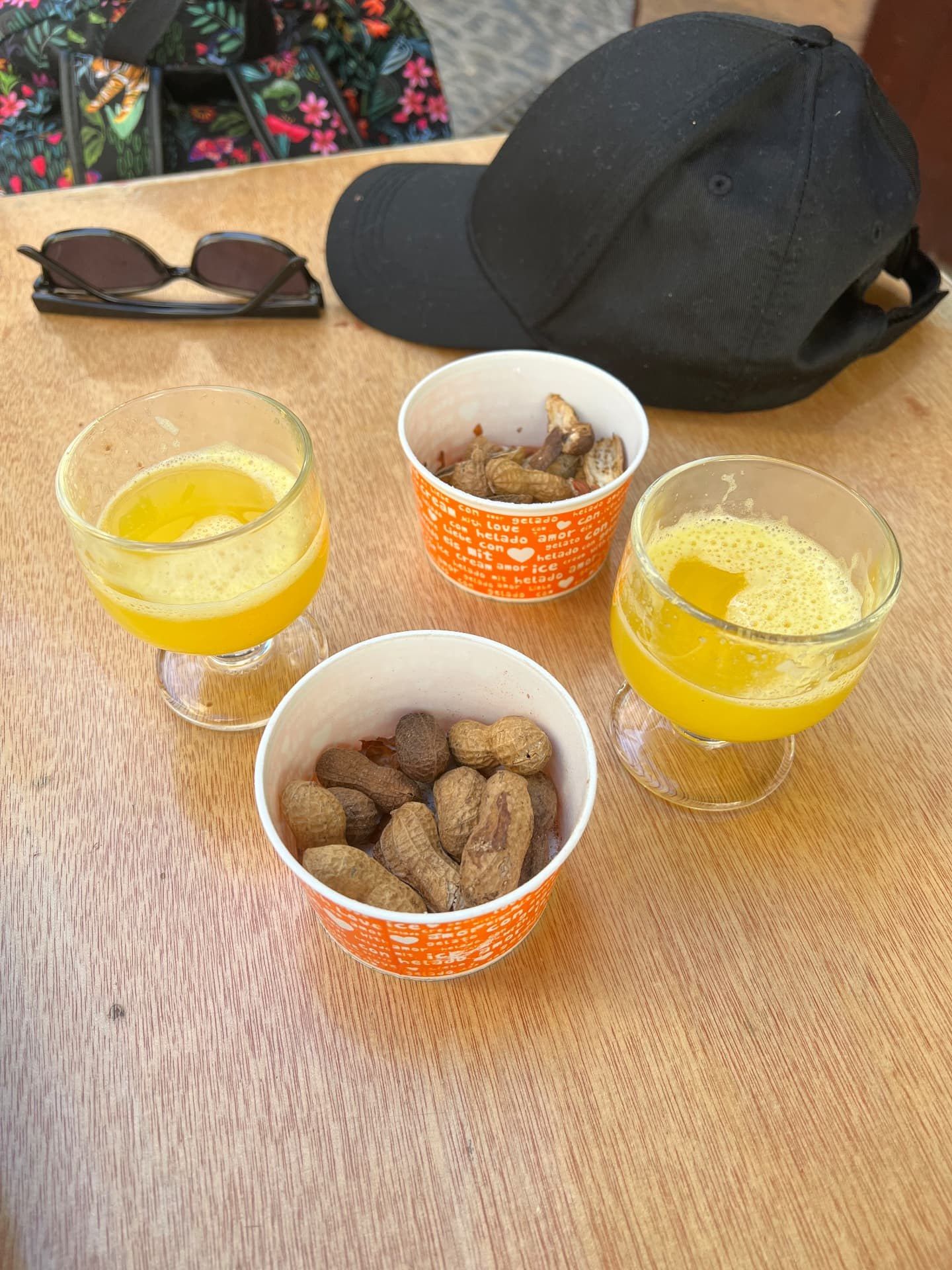Fresh passion fruit poncha with boiled peanuts in their shells at Rei da Poncha bar in Funchal, Madeira