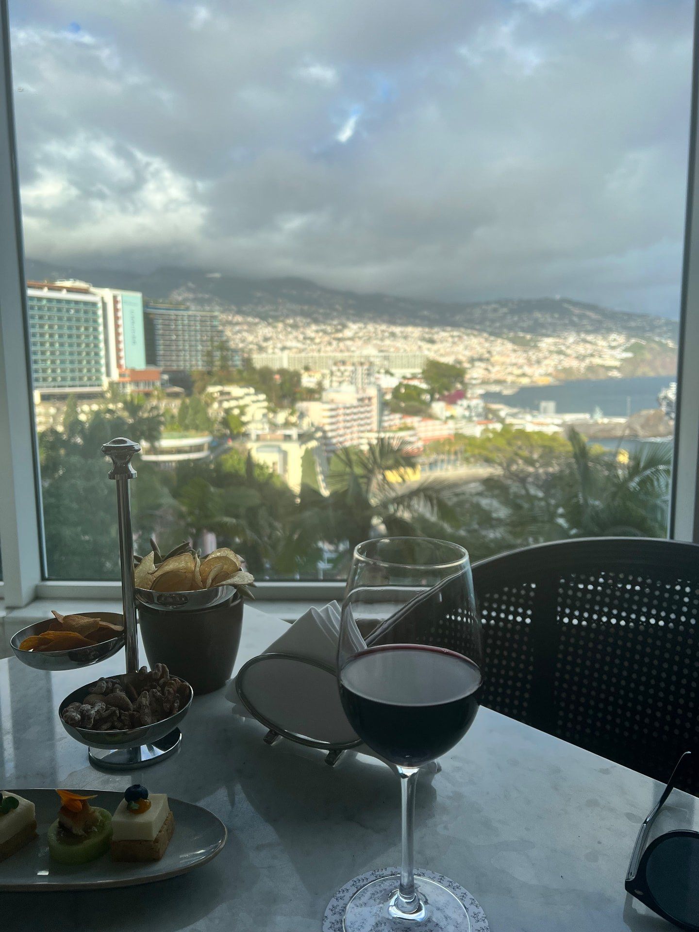 Glass of red wine at Reid's Palace Champagne Bar overlooking Funchal and its marina