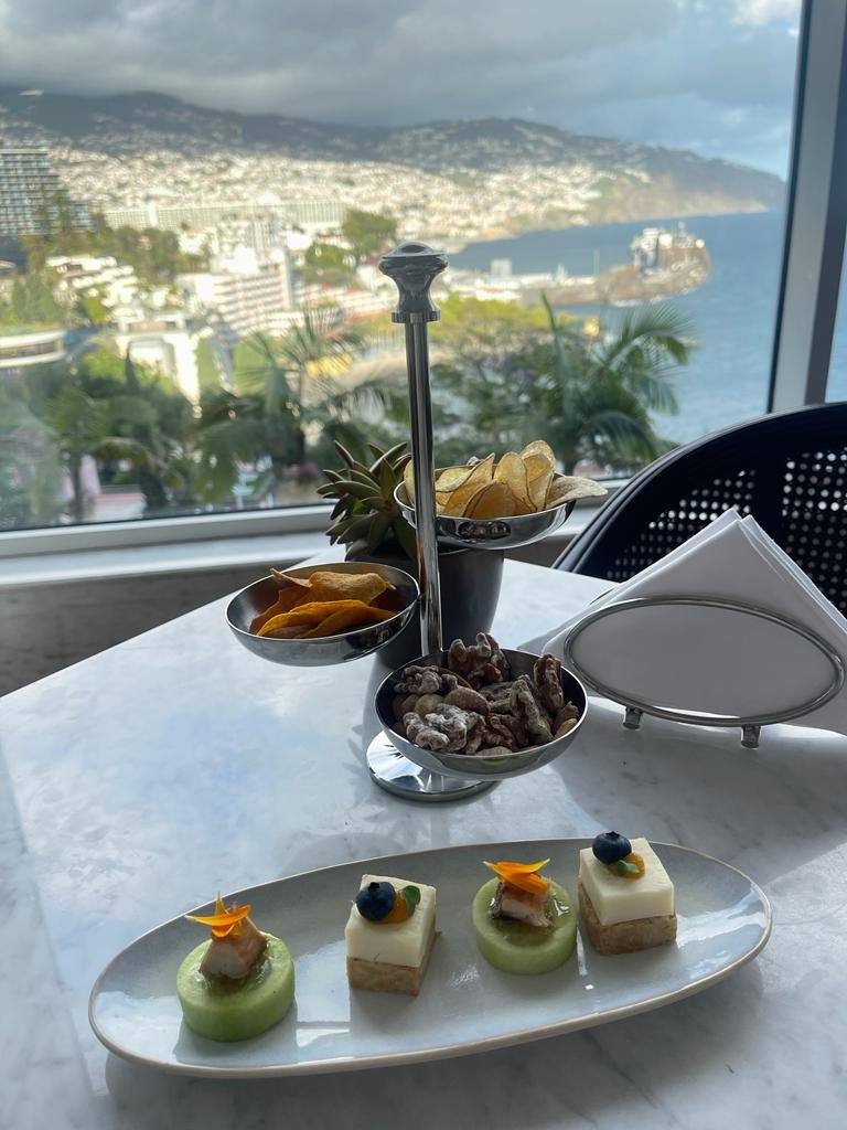 Champagne bar canapes, crisps and candied nuts with a panoramic view over Funchal Bay from Belmond Reids Palace Champagne Bar, Madeira