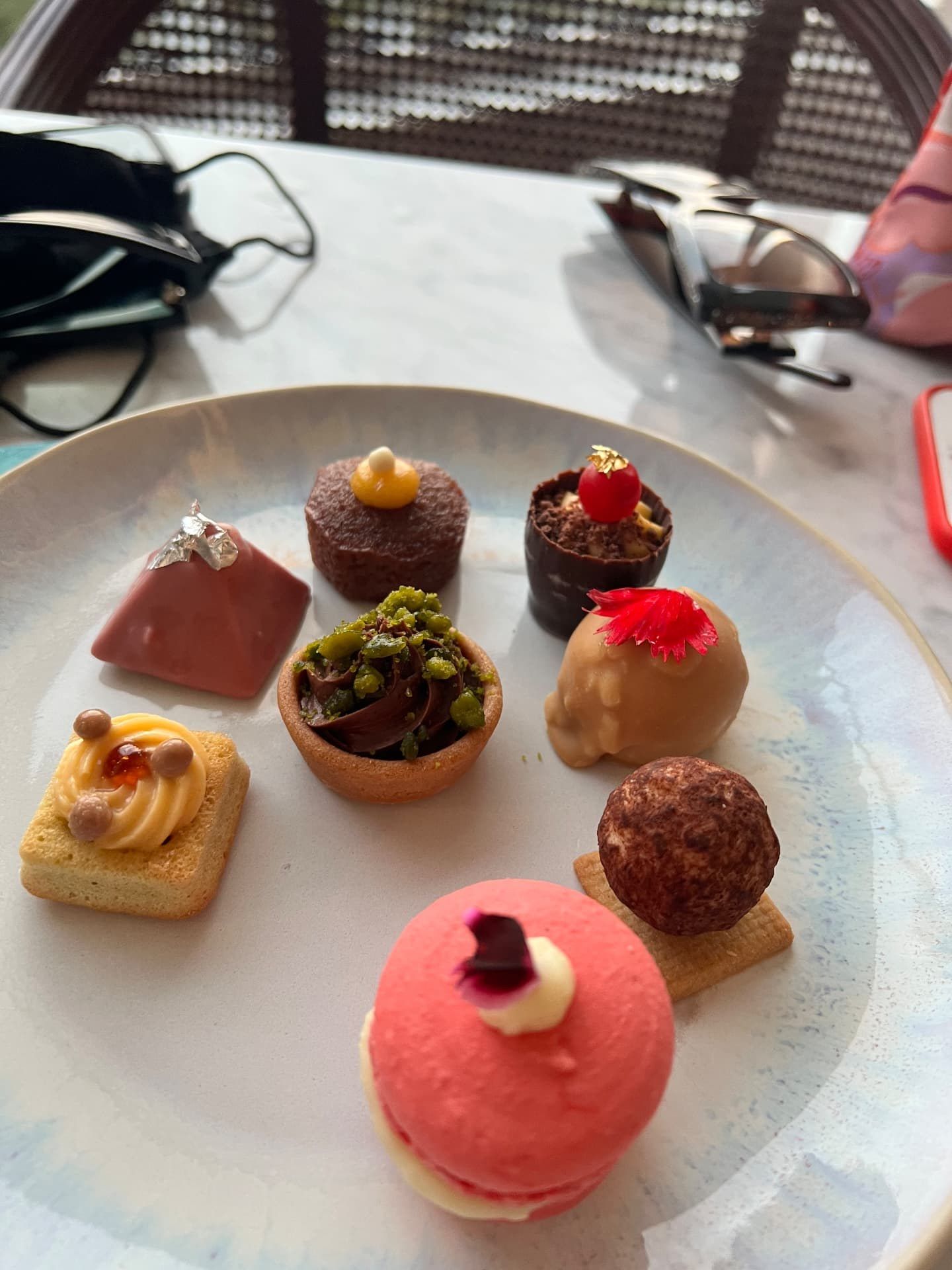 Afternoon tea pastries and petits fours on a plate at Reids Palace Champagne Bar in Funchal, Madeira