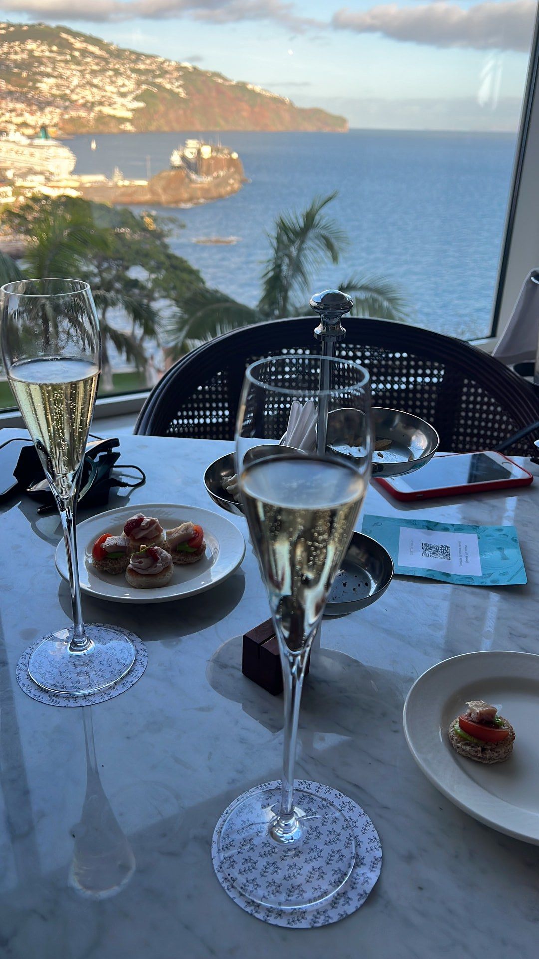 Champagne afternoon tea with canapes overlooking Funchal Bay and a cruise ship at Reids Palace, Madeira