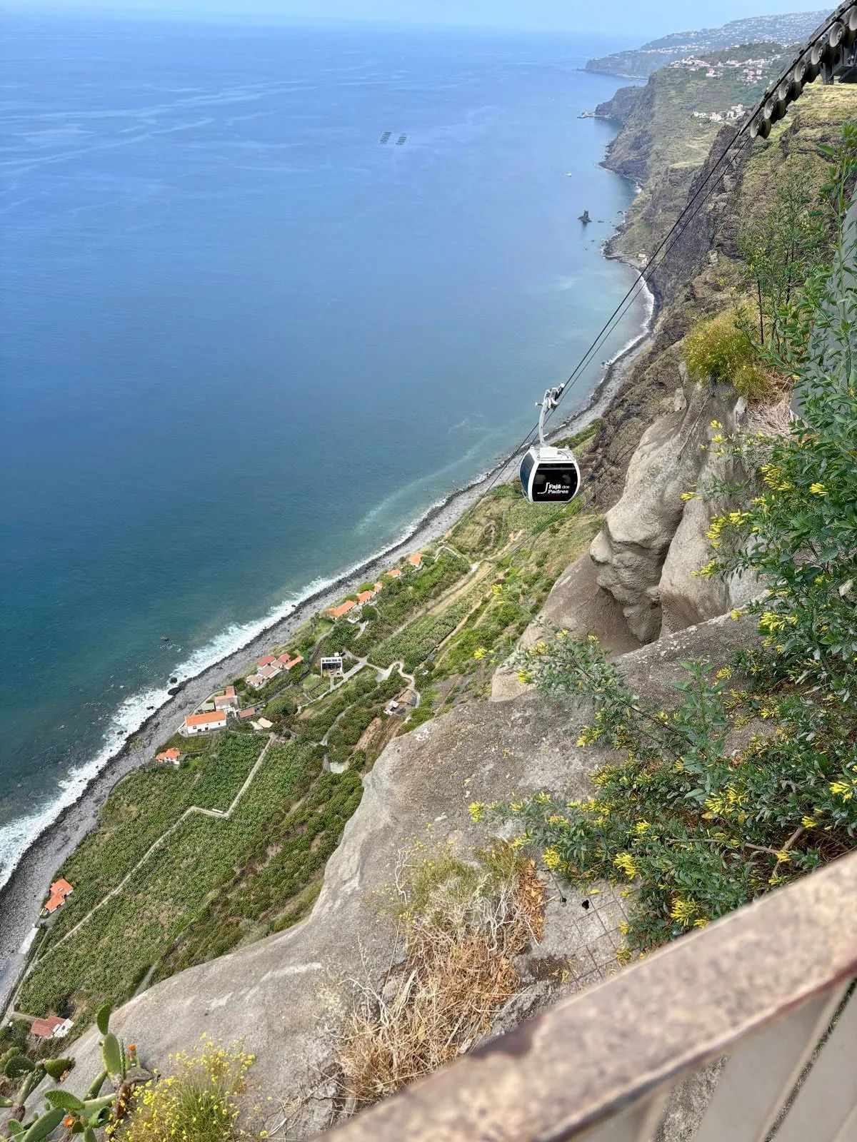 Fajã dos Padres cable car descending the cliff to the pebble beach below
