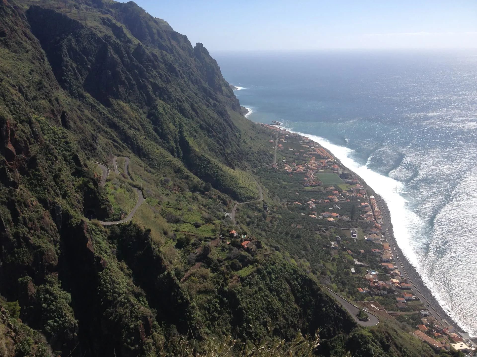 Clifftop view over Paul do Mar village, coastal road and Atlantic Ocean in Madeira