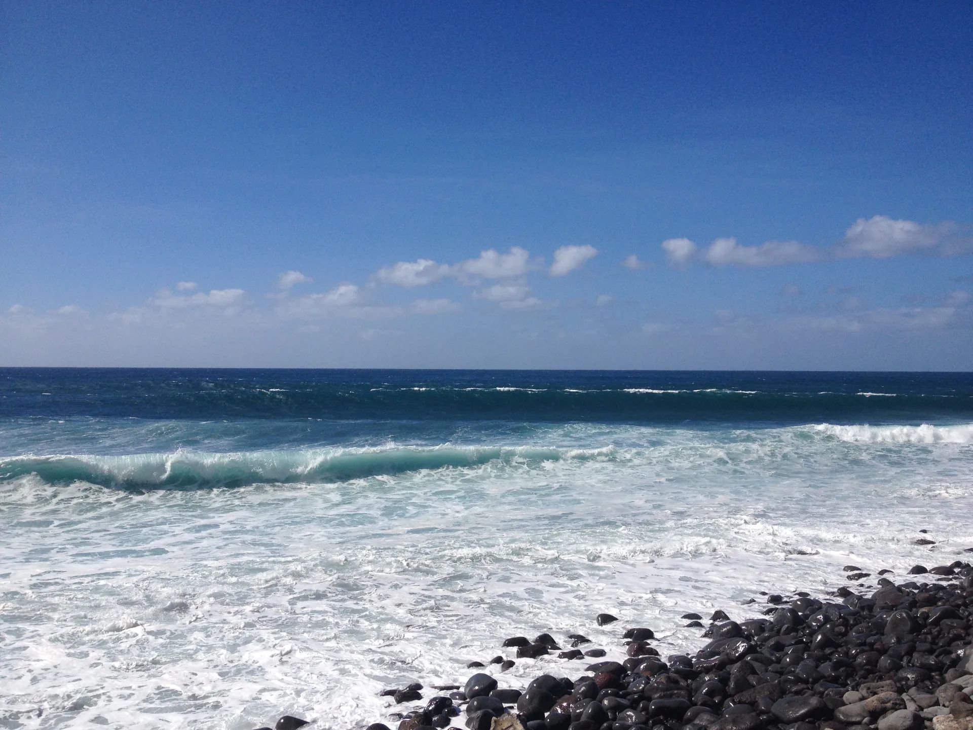 Atlantic surf breaking onto the pebble shore at Paul do Mar, Madeira