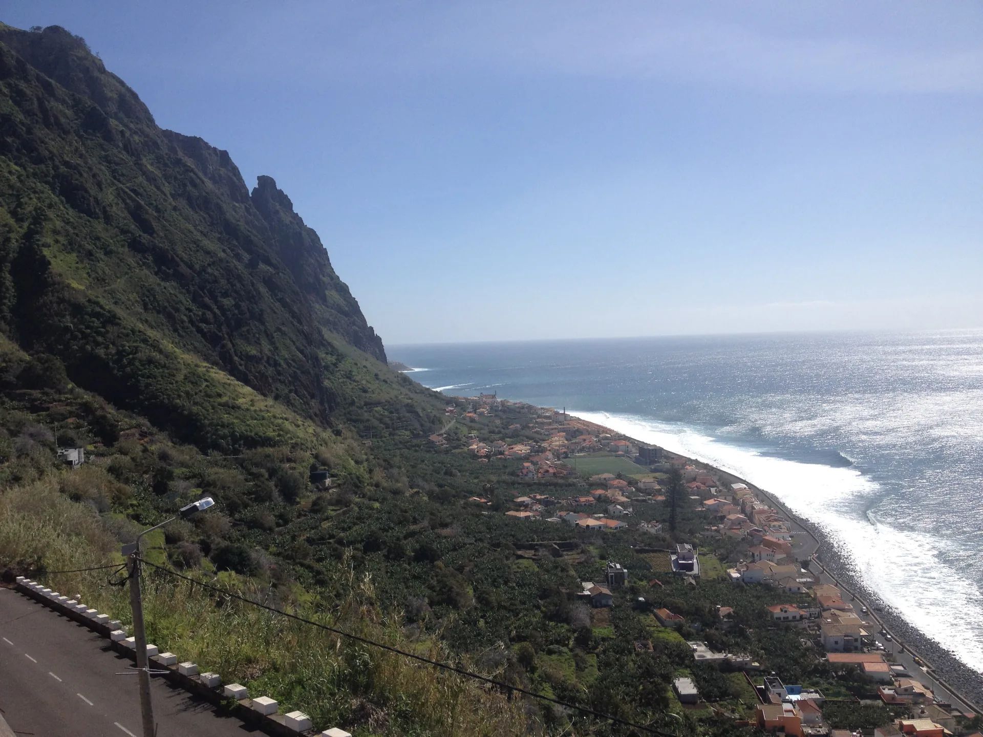 Paul do Mar village between steep green cliffs and the Atlantic coast in Madeira