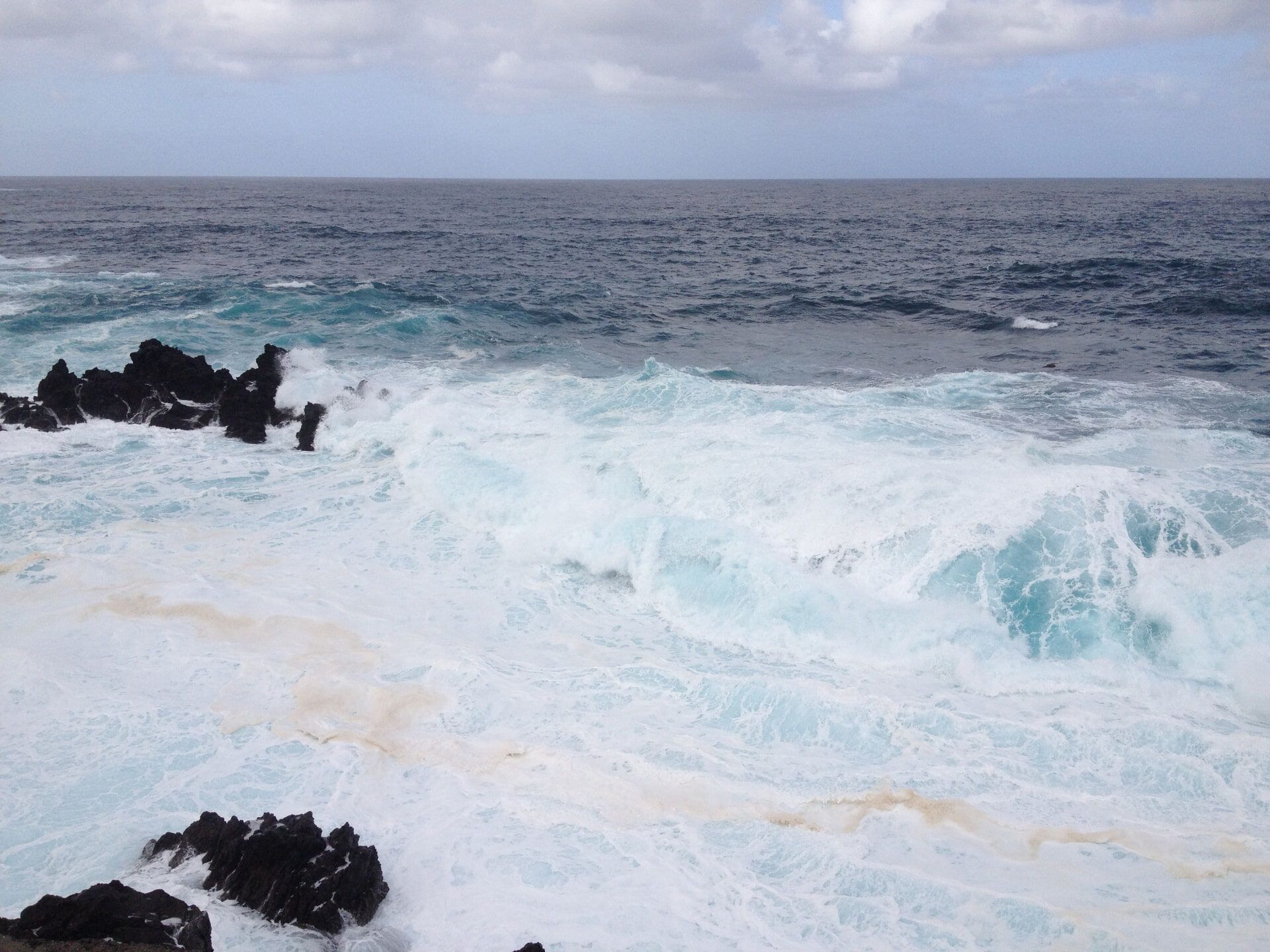 Atlantic waves crashing over the lava rocks at Porto Moniz natural pools