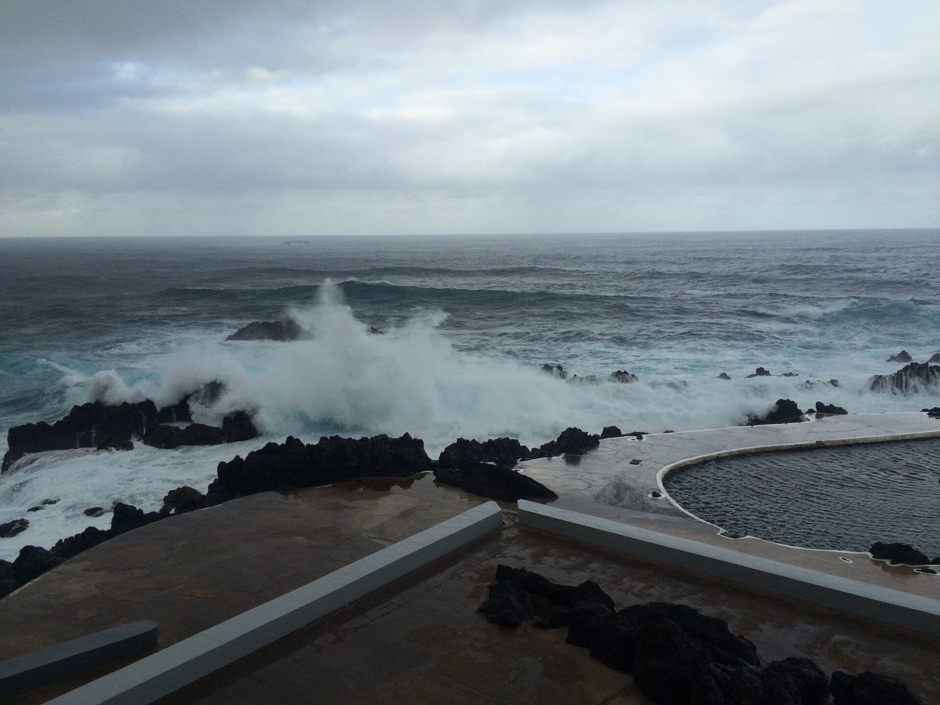 Waves breaking beside the walled sea pool at Porto Moniz