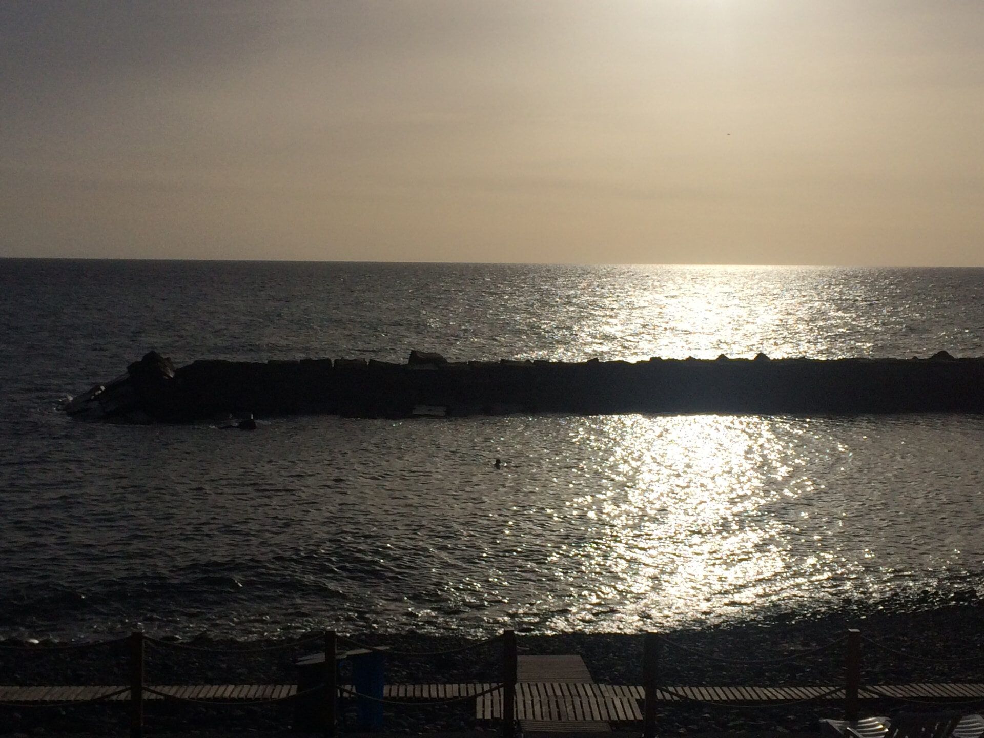 Sunset over the harbour wall at Praia da Ponta do Sol