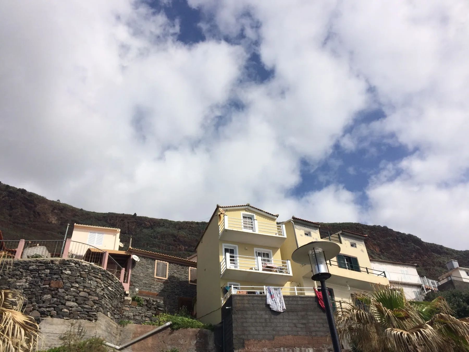 Houses stacked on the slope above the shore at Jardim do Mar