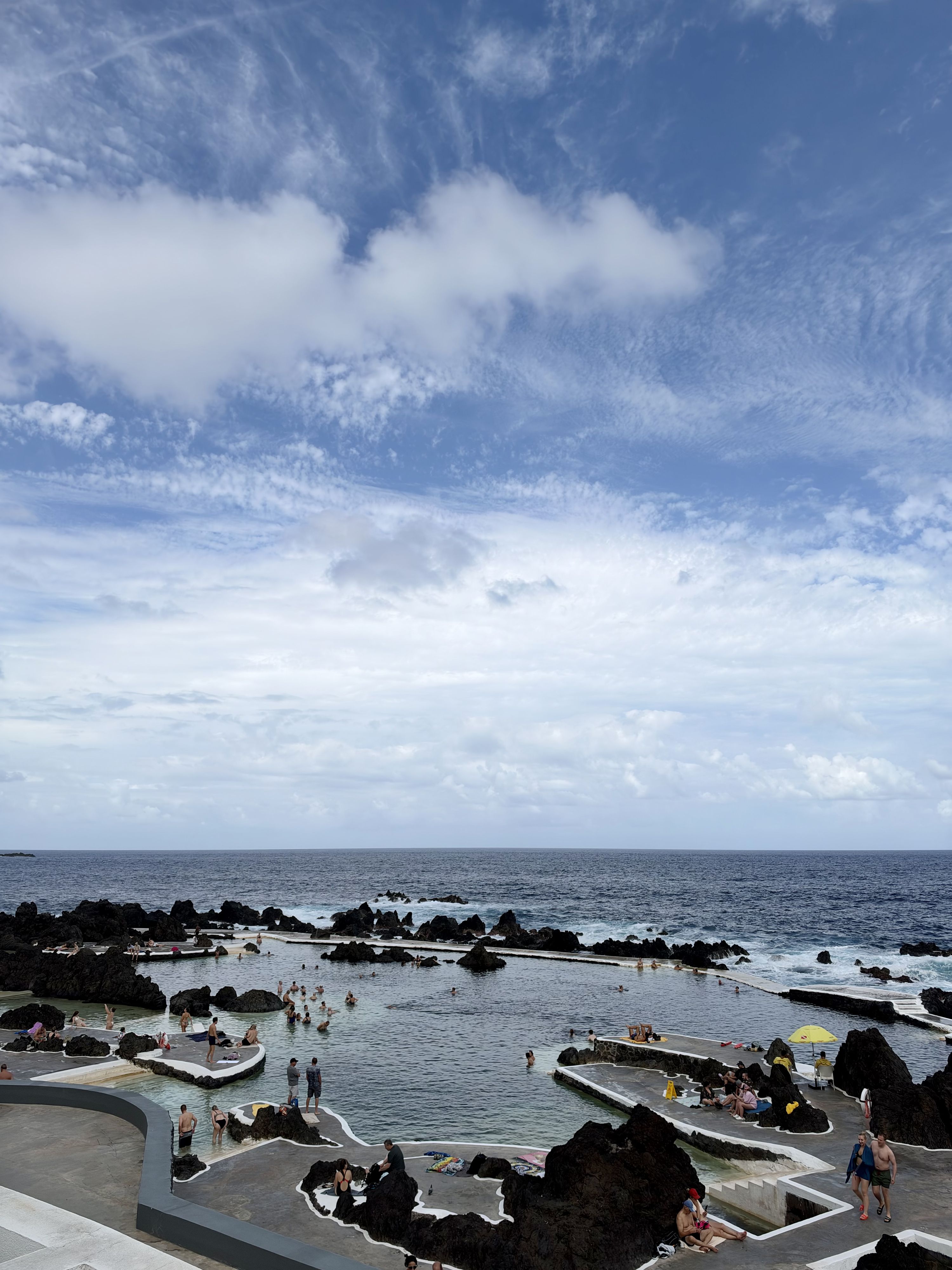 Lava rock pools filled by Atlantic ocean surf at Porto Moniz natural swimming complex, Porto Moniz natural pools: paid complex vs free Cachalote pools, Madeira (photo by @.kris.tina.n)