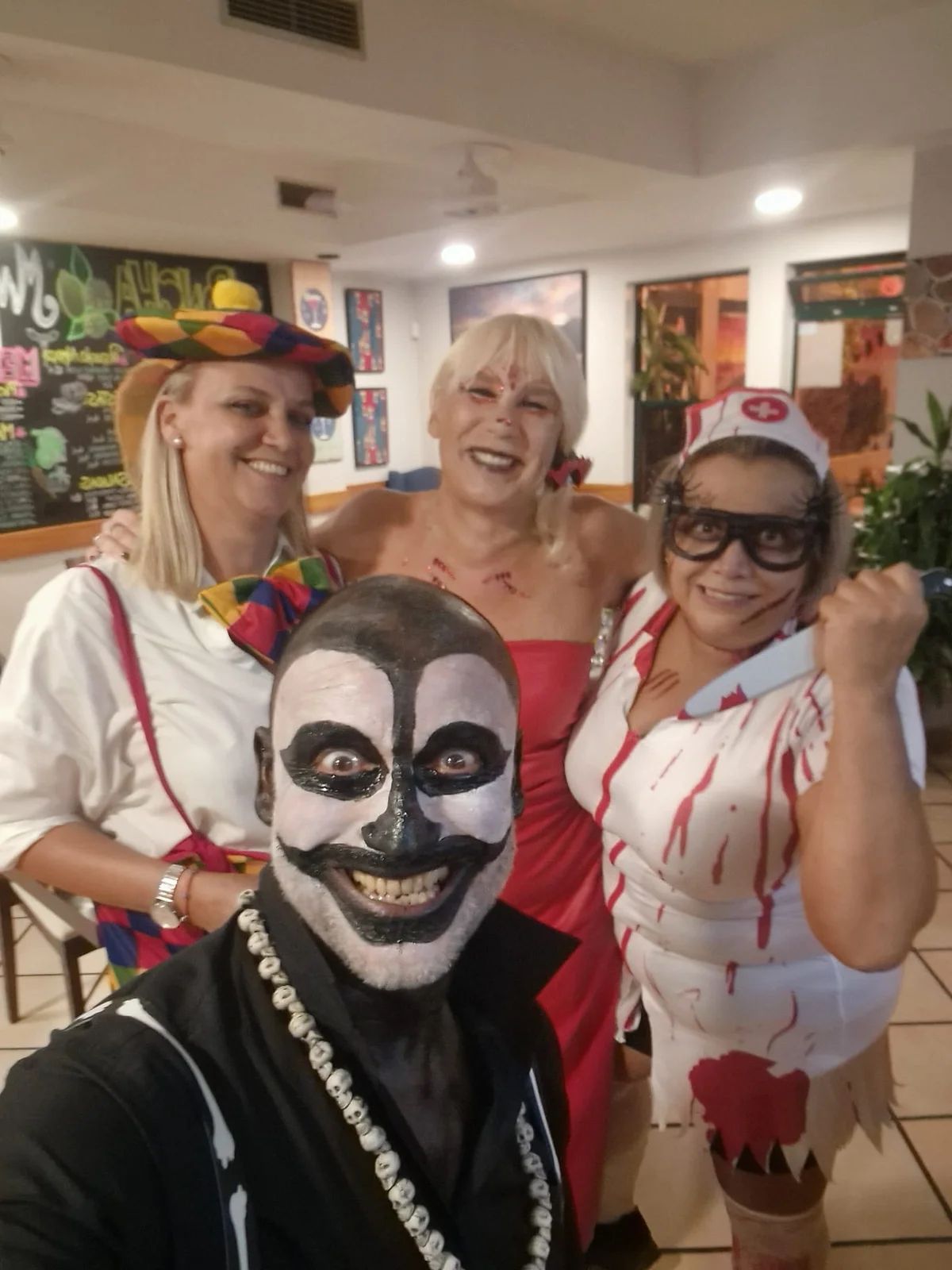 Four friends in homemade Halloween costumes at Munchies, Caniço de Baixo, in 2025