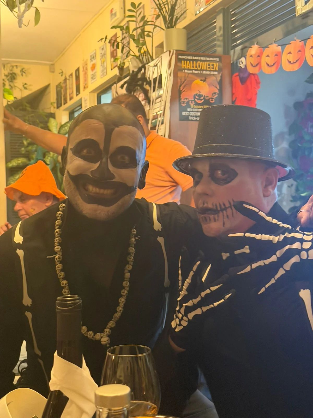 Two friends in skeleton costumes at a table at Munchies in 2025