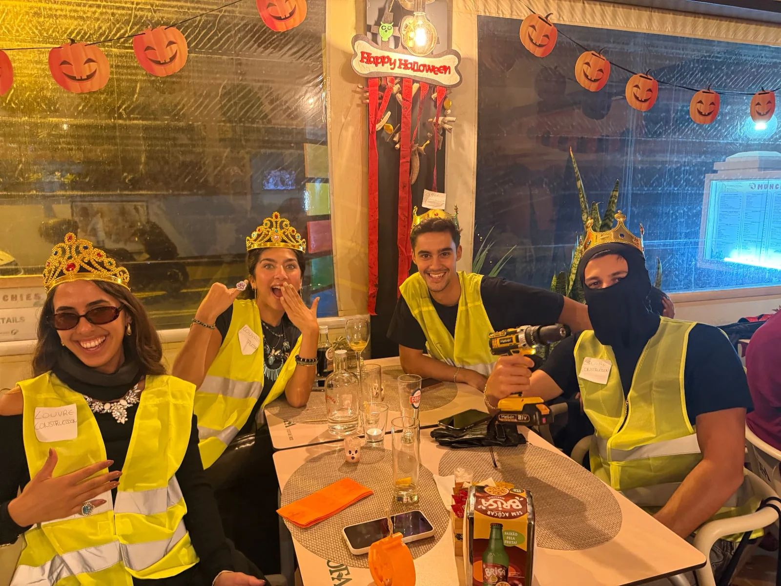 A group in hi-vis vests and paper crowns at a decorated table at Munchies in 2025