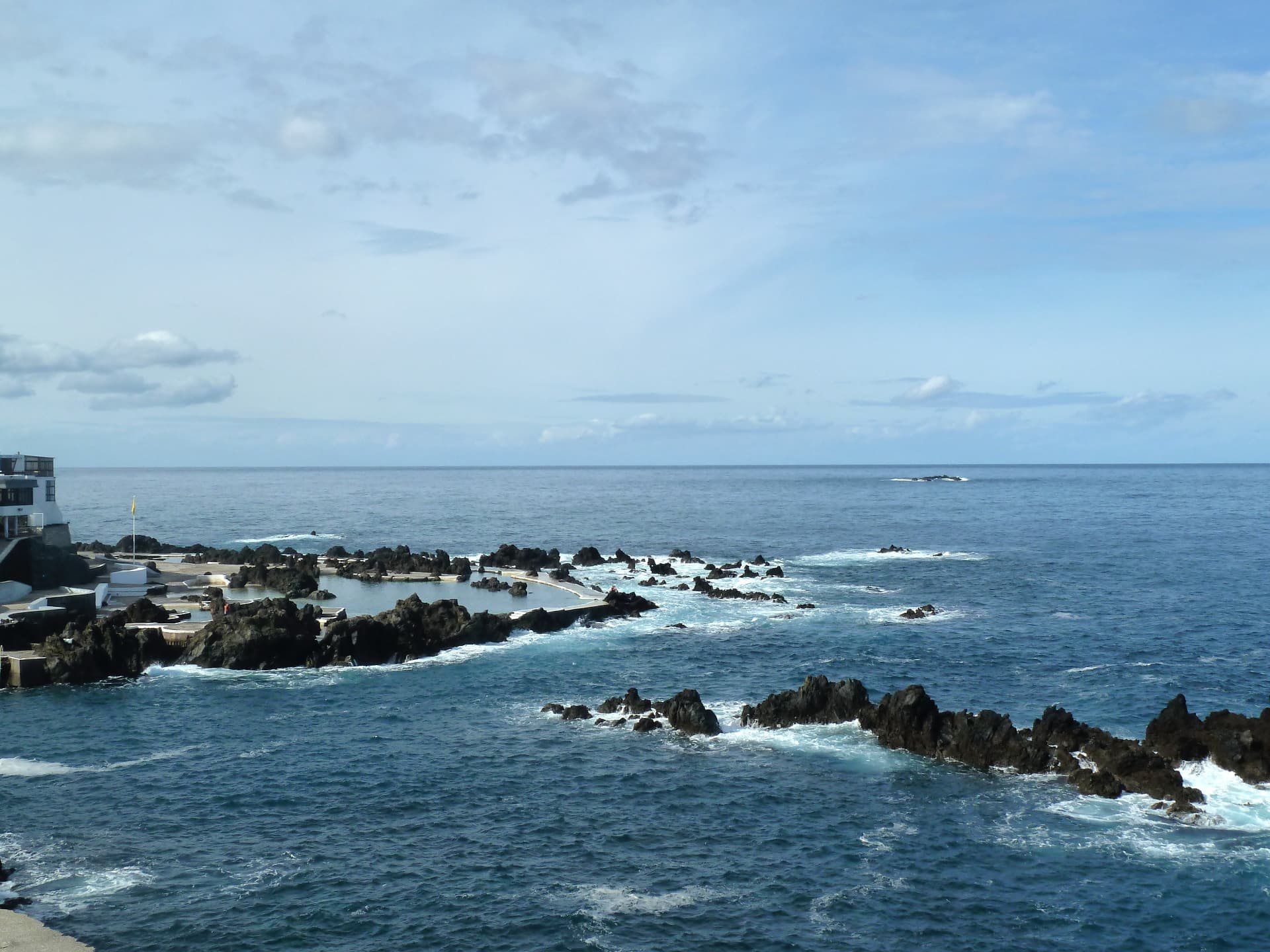Natural seawater pool among black volcanic rocks on the Madeira coast.