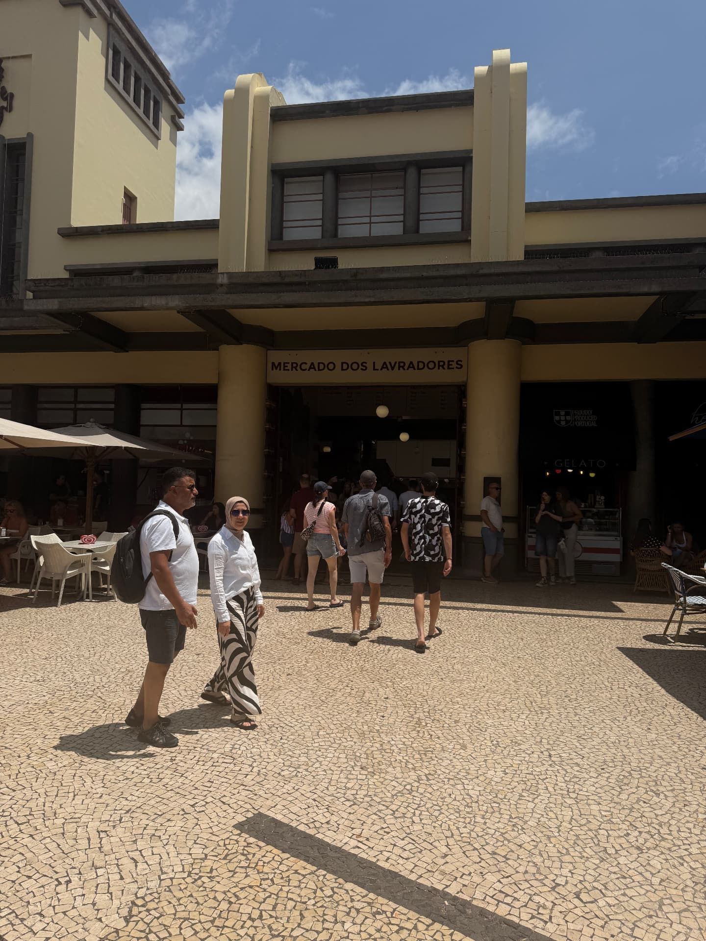 Visitors crossing the calcada square in front of the main entrance of Mercado dos Lavradores, Funchal.