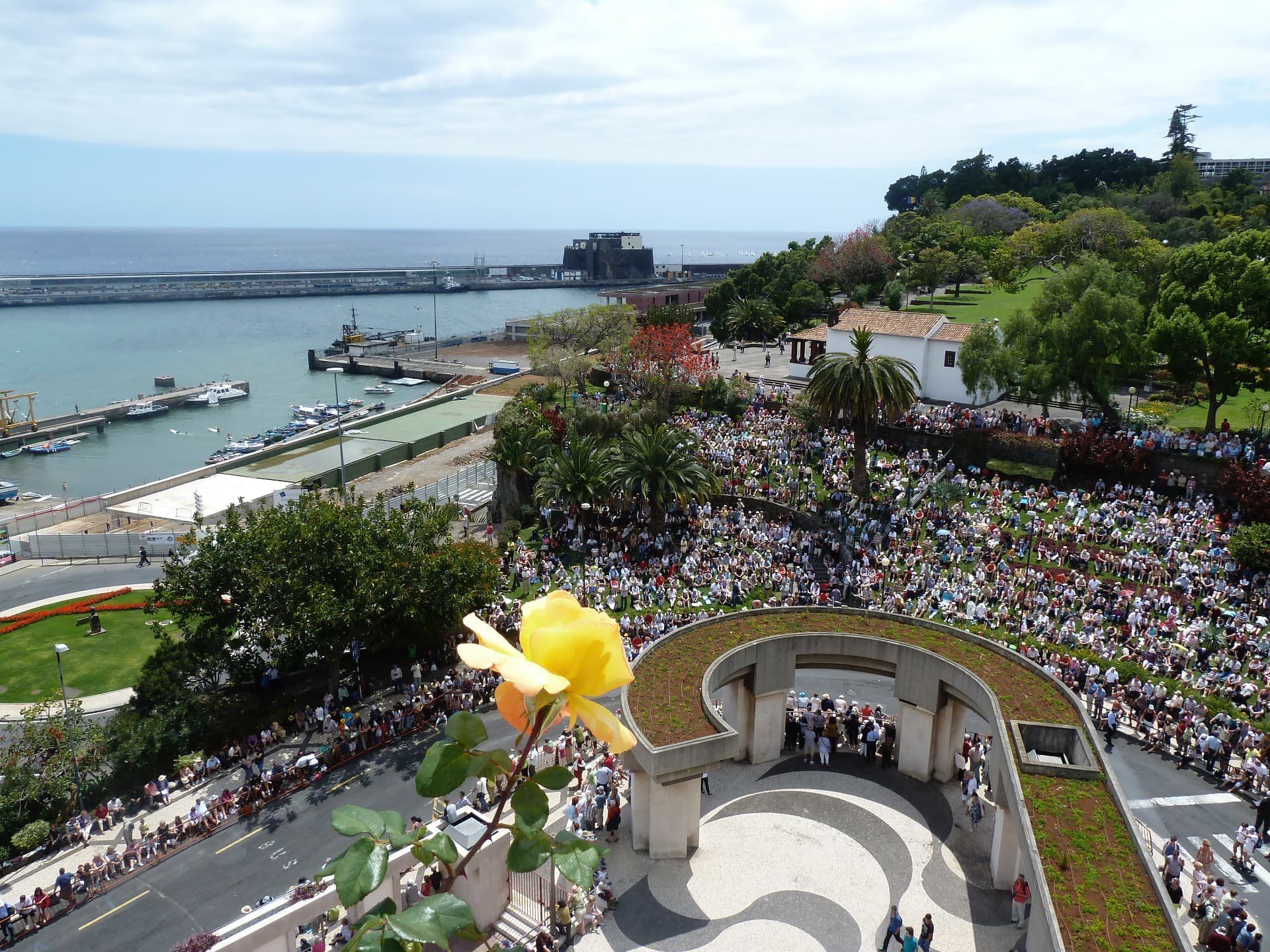 Flower Festival crowds beside Funchal harbour, seen from above.