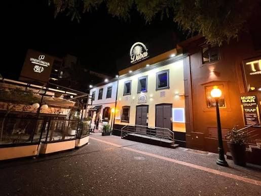 Dubai Club Funchal frontage lit up at night, with its palm-tree sign above the entrance