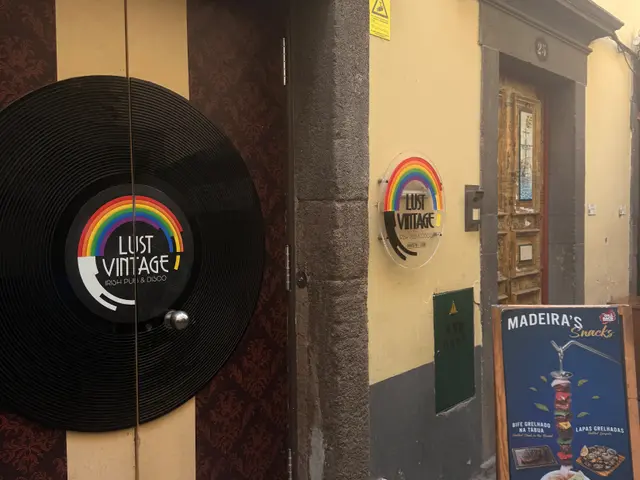 Lust Vintage entrance with vinyl record decoration and rainbow flag on a yellow façade
