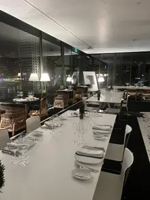 Waterfront dining room at Design Centre Nini Andrade Silva overlooking Funchal harbour at night
