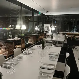 Waterfront dining room at Design Centre Nini Andrade Silva overlooking Funchal harbour at night