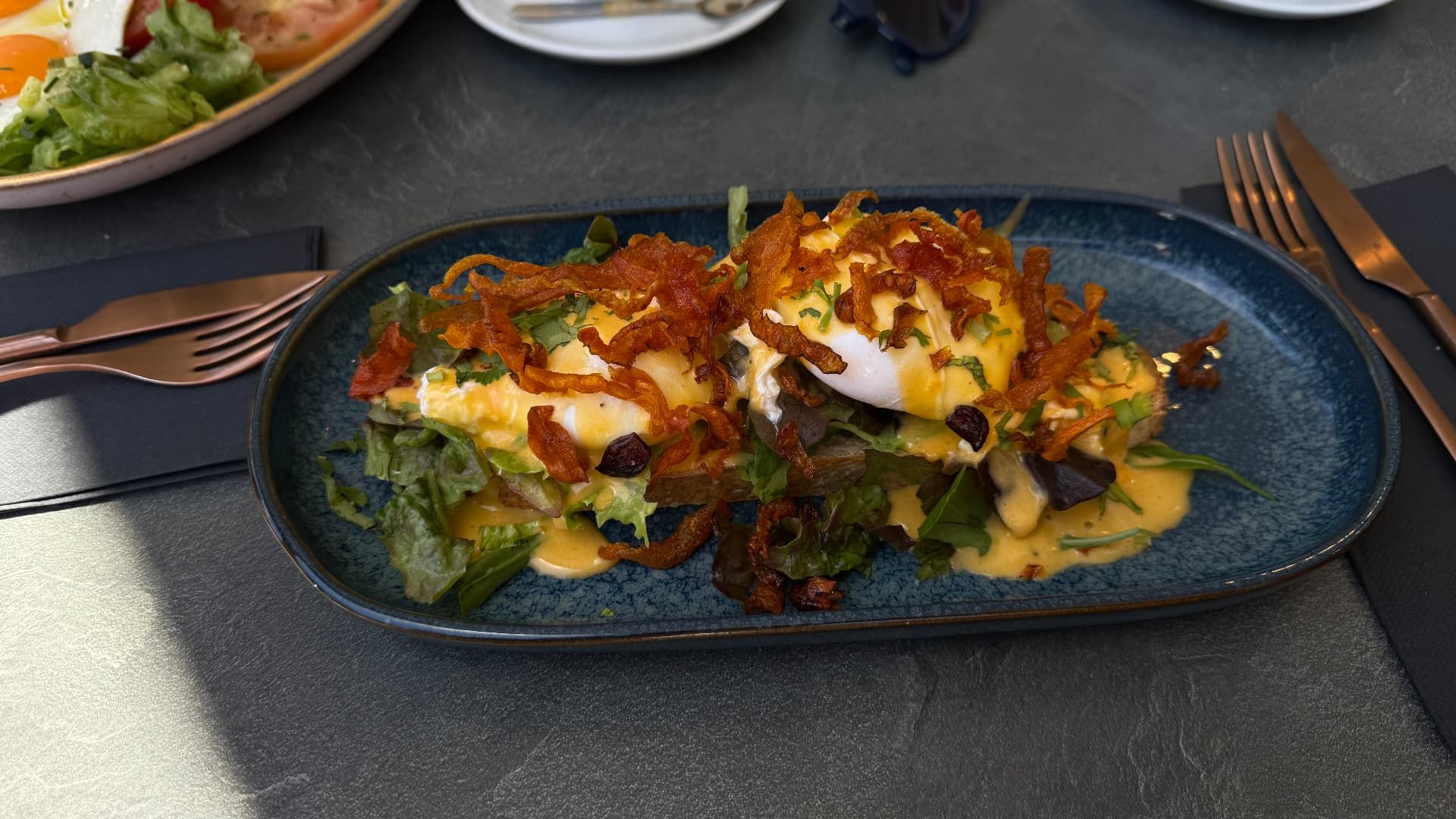 Eggs benedict with hollandaise and crispy onions at Fuga Bistro Bar, Caniço de Baixo, Madeira