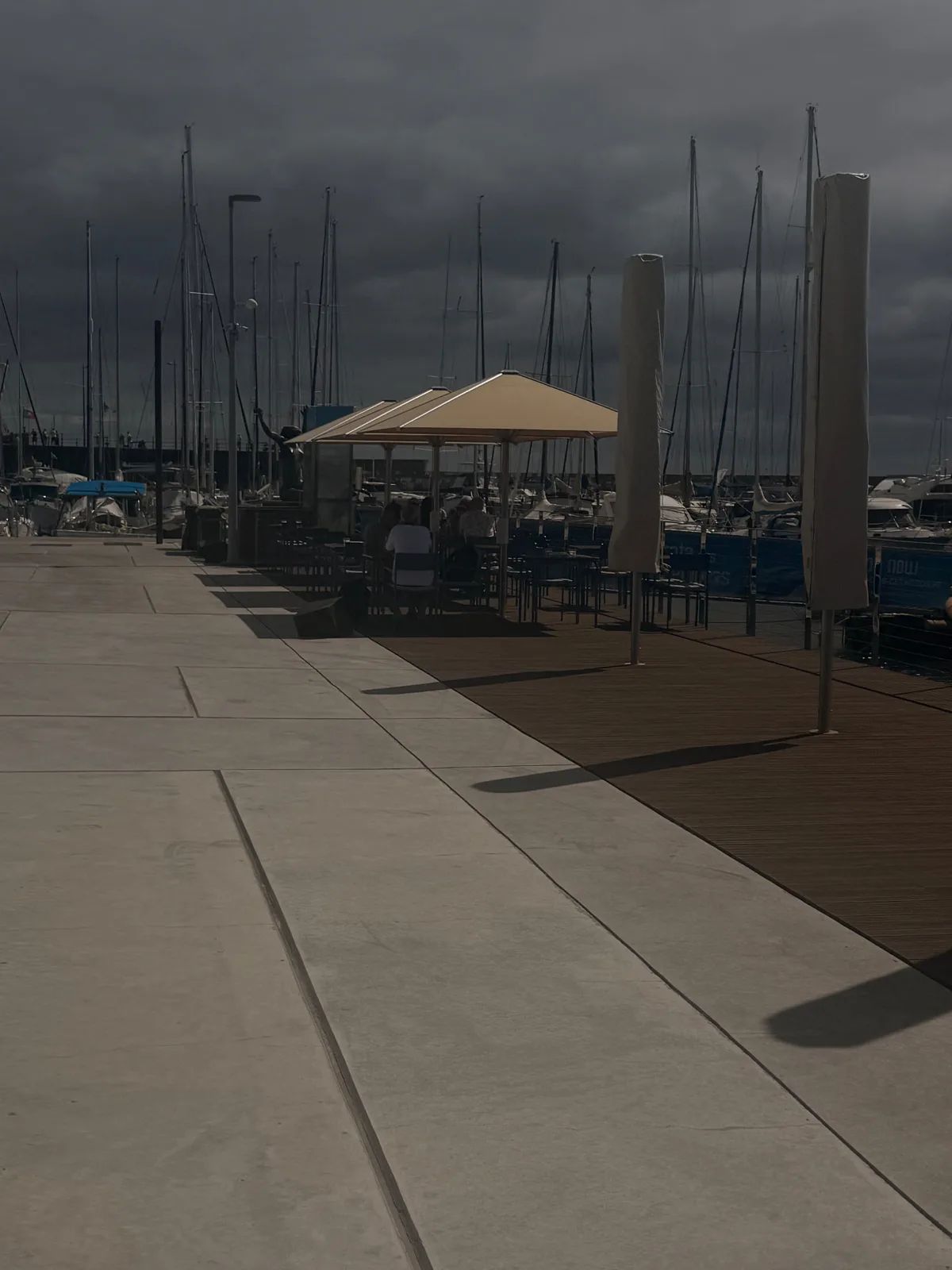 Wooden deck and parasols of Marisqueira na Marina along the marina quay