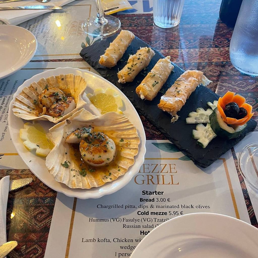 Scallops in the shell with garlic butter and filo rolls, hot mezze starter at Mezze Grill restaurant in Funchal, Madeira