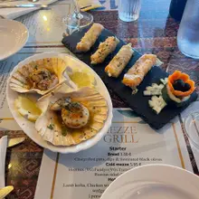 Scallops in the shell with garlic butter and filo rolls, hot mezze starter at Mezze Grill restaurant in Funchal, Madeira