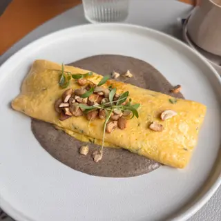 Mushroom and cashew omelette over mushroom cream at Nomade brunch restaurant in Funchal, Madeira