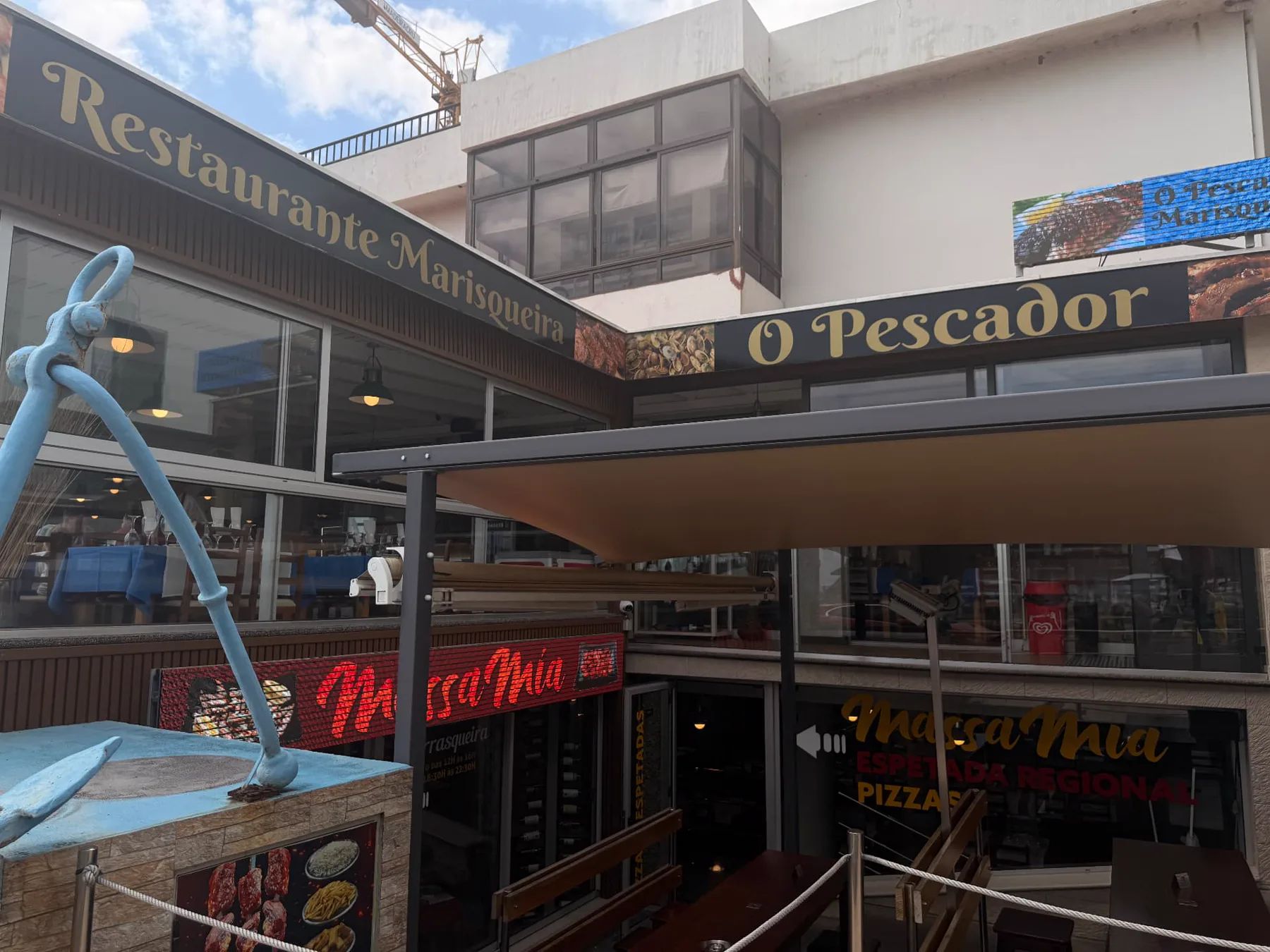 Blue anchor and entrance at Restaurante Marisqueira O Pescador in Machico