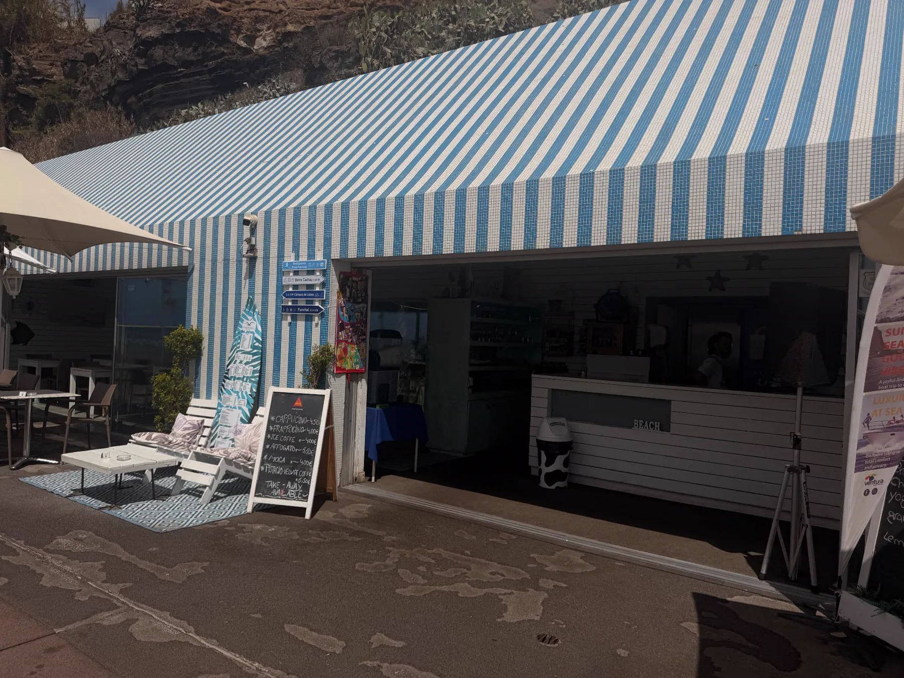 Front entrance and open counter of Restaurante Praia Formosa, with blue-and-white tiles, outdoor seating and menu board.