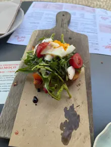 Caprese-style sourdough toast with mozzarella, cherry tomatoes and rocket at Prima Caju brunch cafe in Funchal, Madeira