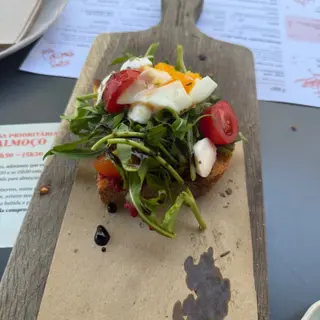 Caprese-style sourdough toast with mozzarella, cherry tomatoes and rocket at Prima Caju brunch cafe in Funchal, Madeira
