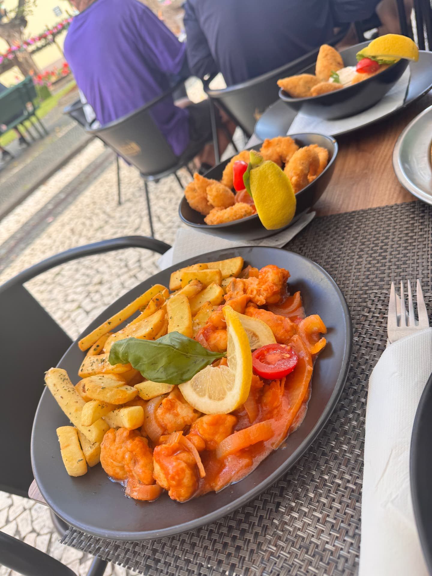 Garlic prawns in tomato sauce with crispy chips, lemon and basil at Rota dos Sabores, Santa Cruz, Madeira