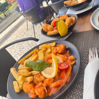 Garlic prawns in tomato sauce with crispy chips, lemon and basil at Rota dos Sabores, Santa Cruz, Madeira