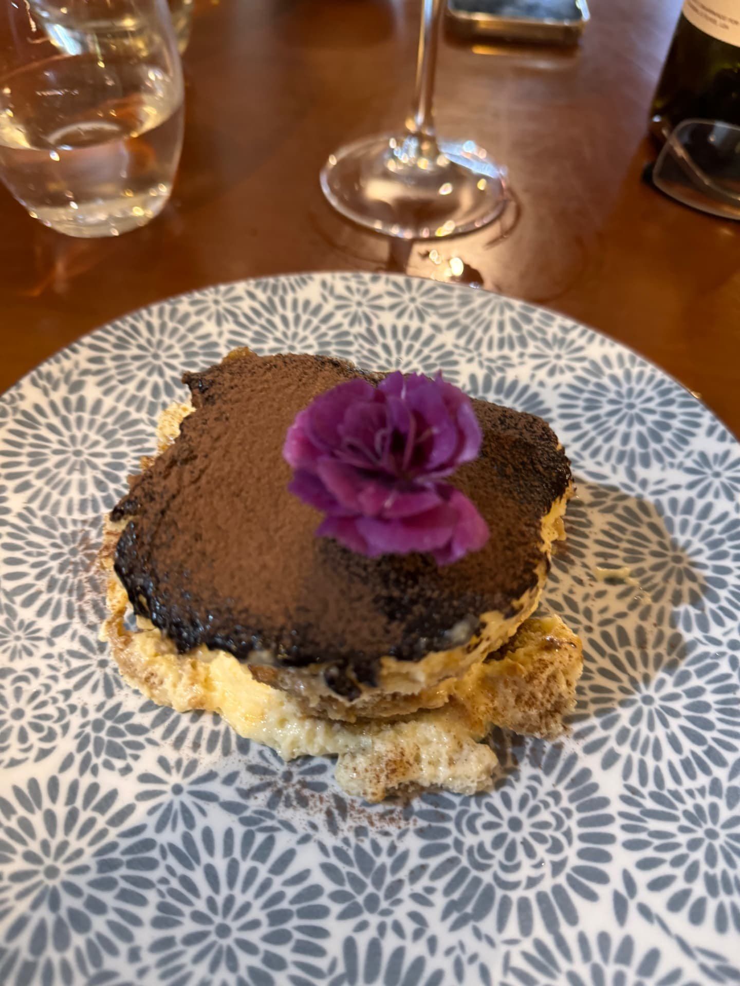 Tiramisu with cocoa dusting and flower garnish at 5 Sentidos restaurant, Funchal, Madeira