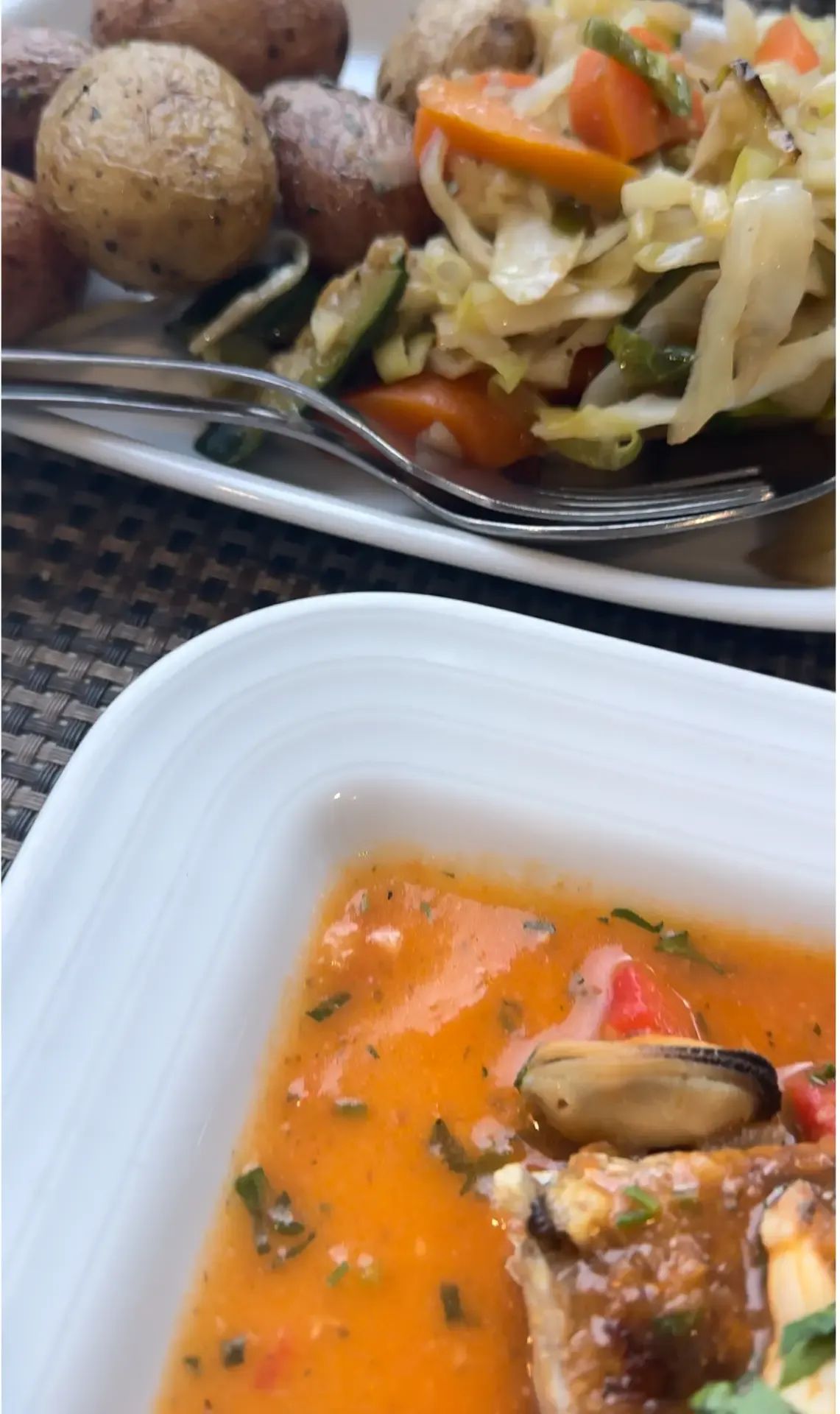 Seafood dish in tomato broth served with herbed new potatoes and sautéed vegetables at A Traineira, Caniço