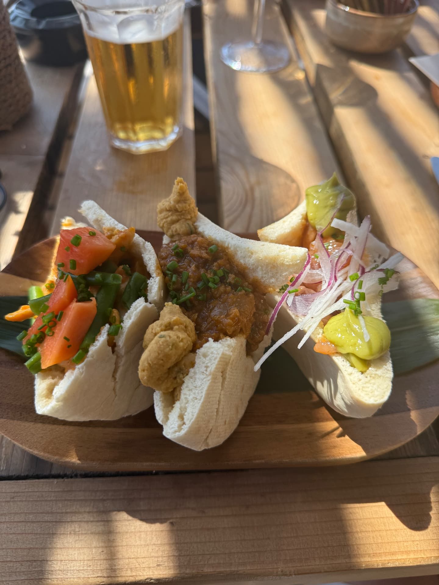Filled bao-bun sharing board with beer at Calhau Beach Club, Calheta, Madeira
