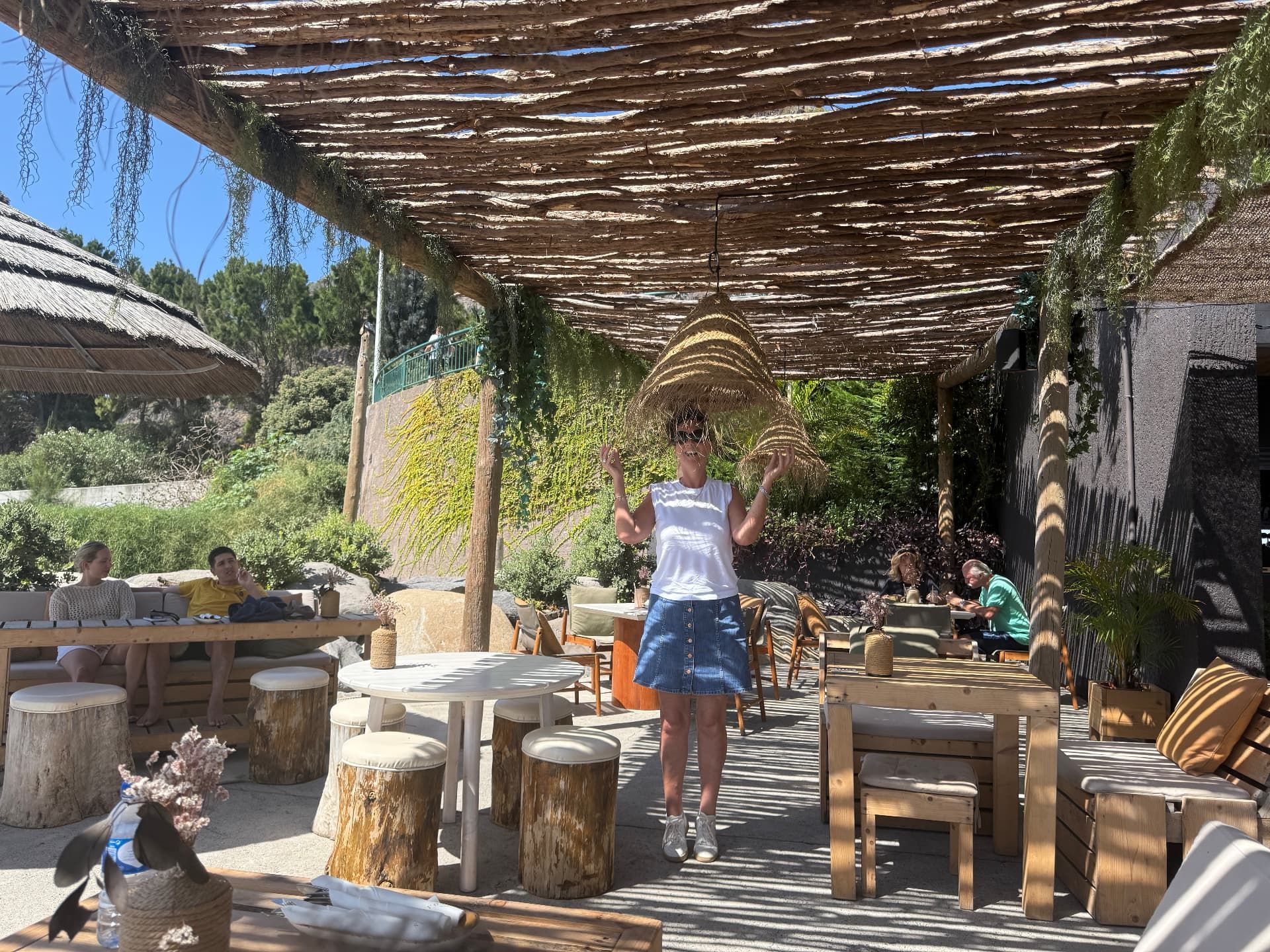 Thatched pergola terrace at Calhau Beach Club on the Calheta seafront, Madeira