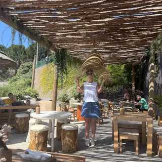 Thatched pergola terrace at Calhau Beach Club on the Calheta seafront, Madeira