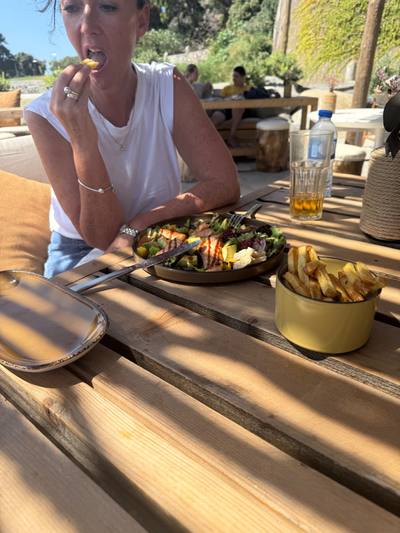 Grilled chicken salad and chips on the terrace at Calhau Beach Club, Calheta
