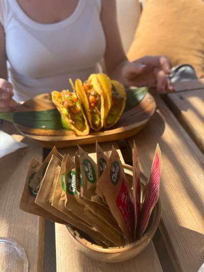 Prawn tacos served on a wooden board at Calhau Beach Club, Calheta