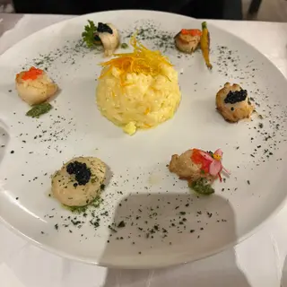Seafood risotto with candied orange zest ringed by seared scallops with caviar and roe at Franco's Corner restaurant, Sao Martinho, Funchal, Madeira